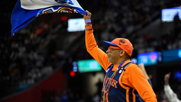 Spike Lee waves a towel during a Knicks game.